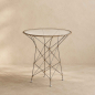 Preview: Funky Café Tisch, runde Glasplatte mit Rattanrand auf diagonal gekreuztem Stahlgestell, ICONS-Kollektion, Design Yuzuru Yamakawa 1996