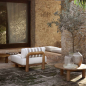 Preview: Tine K Teak Modul Sofa im mediterranen Innenhof — Steinwand, Olivenbaum, Teak Couchtisch, cremefarbene Kissen mit Streifen