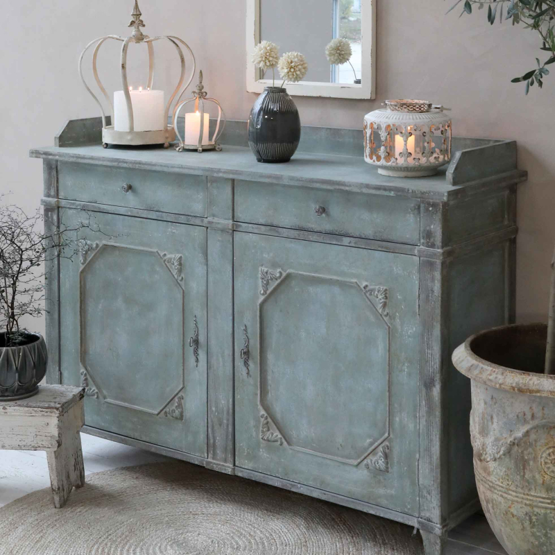 Preview: Provençalischer Schranktisch in grau-blau als Sideboard im Wohnzimmer — dekoriert mit Kerzen und Vasen, Kiefer massiv, antique opal Finish, Provence-Stil